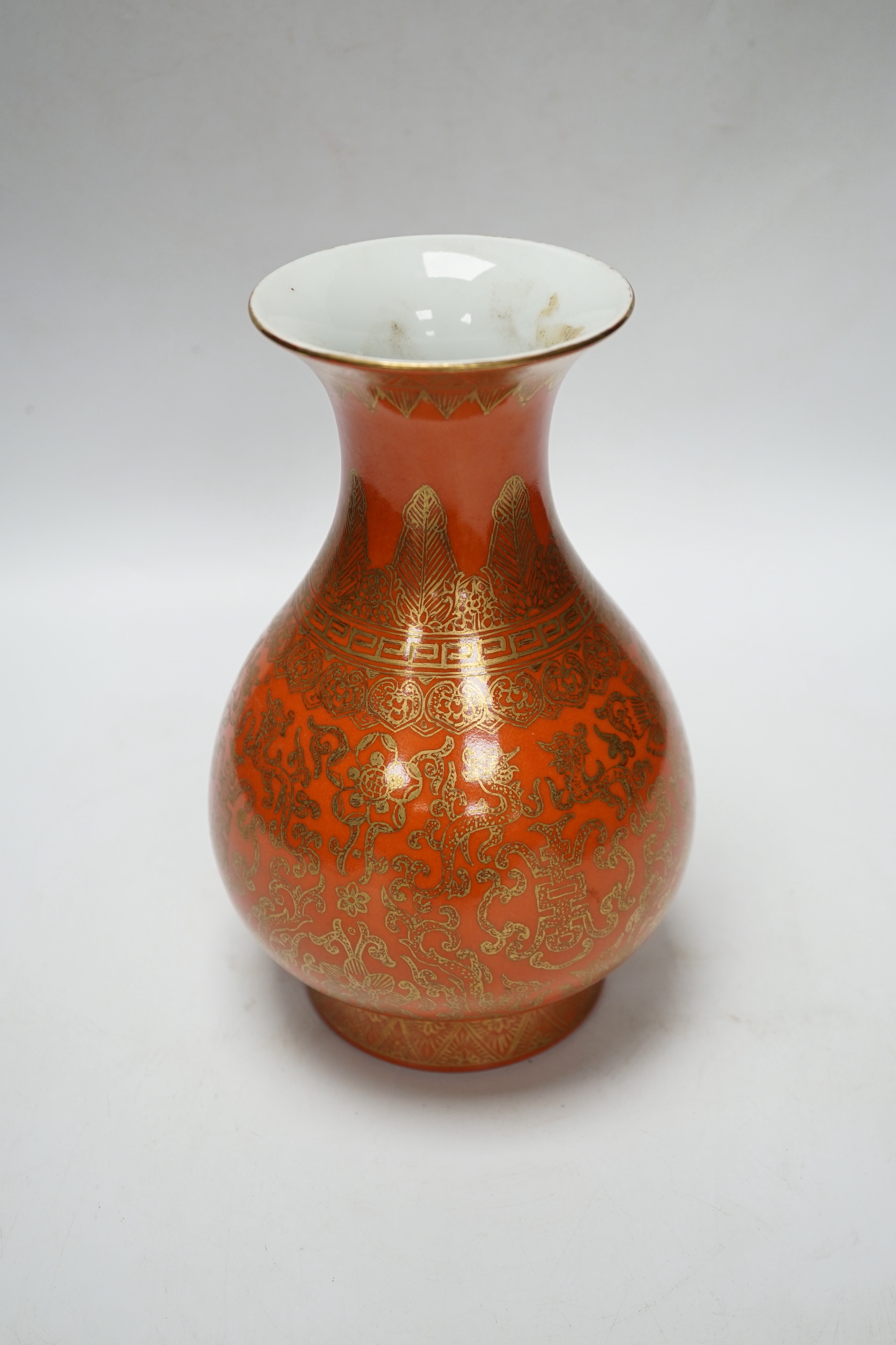 A Chinese coral ground and gilt vase, Qing mark, 21cm